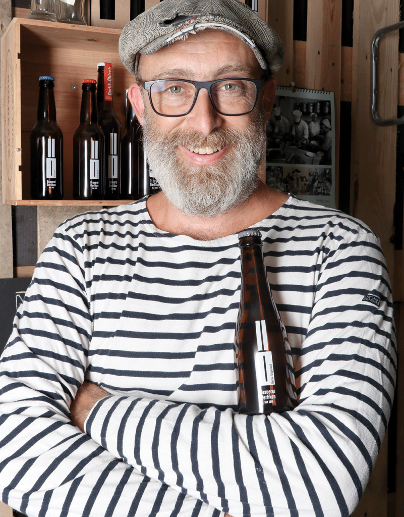 Daniel Frei the brewer of the brewery Oerlikon with his personalized beer bottle